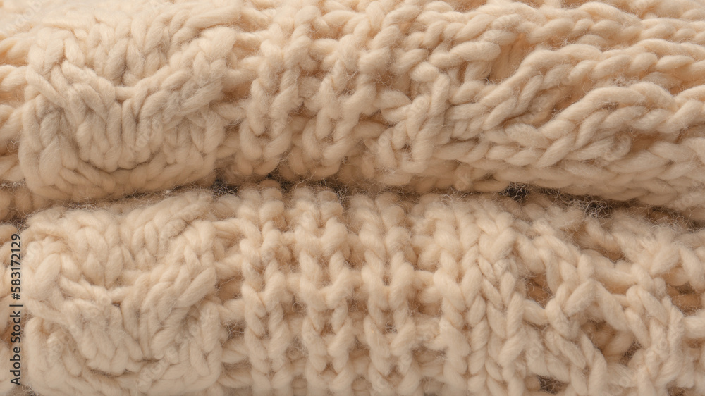 A fragment of beige knitted fabric, knitted from white sheep wool. A fragment of beige knitted fabric, knitted from white sheep wool.