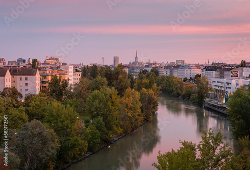 Evening city scape over the Danube canal (Donaukanal) with buildings and parks