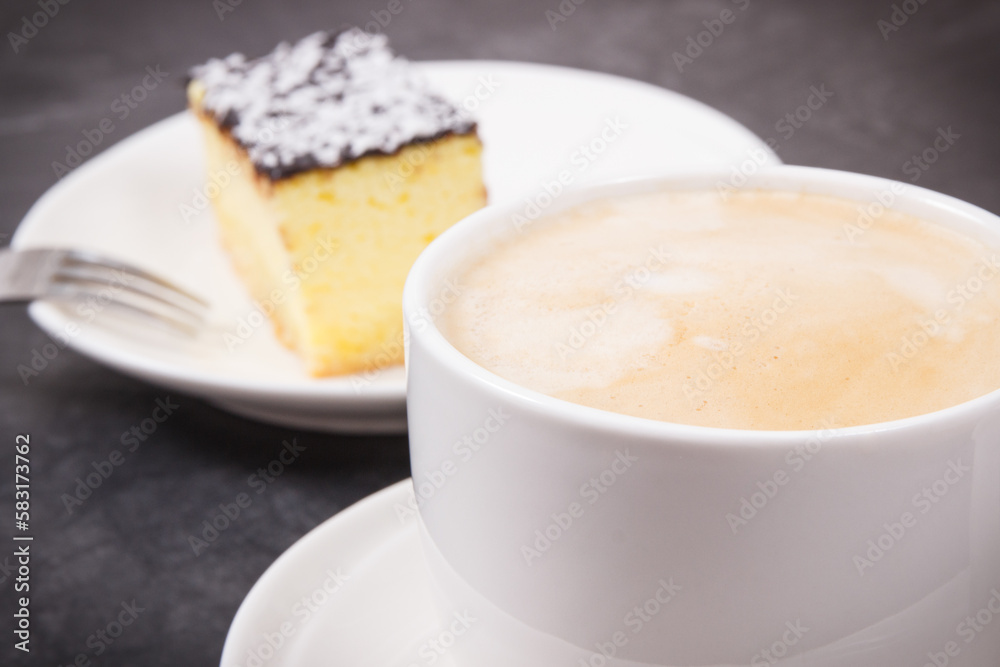 Cup of coffee with milk and fresh baked cheesecake. Delicious dessert Cup of coffee with milk and fresh baked cheesecake. Delicious dessert