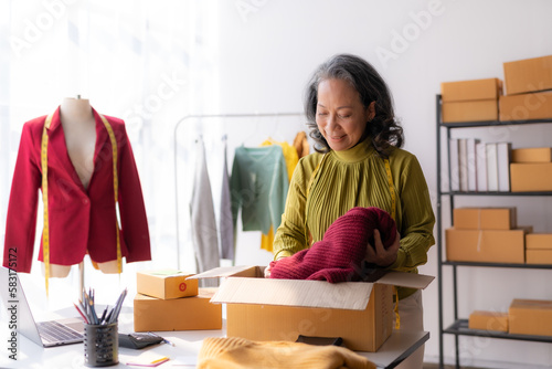 Asian female store owner retire from working to sell online sell clothes at home.