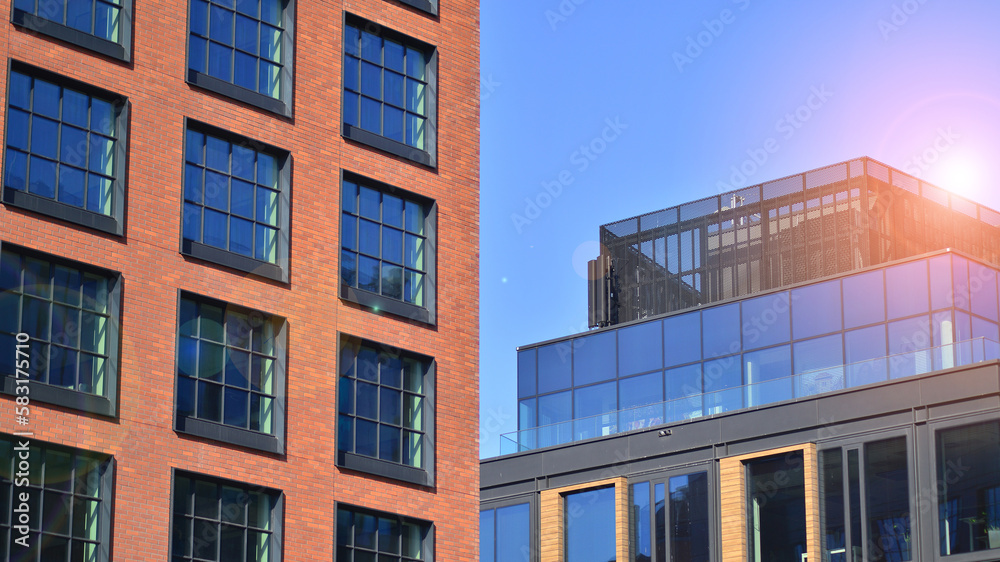 A modern corporate building in the city. The blue sky is reflected in the buildings large glass windows. Glass facade. A modern corporate building in the city. The blue sky is reflected in the buildings large glass windows. Glass facade.