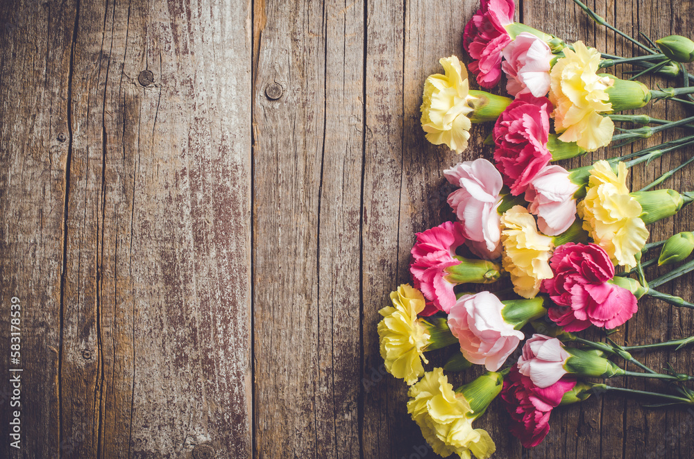 Carnation flowers on wooden table Carnation flowers on wooden table