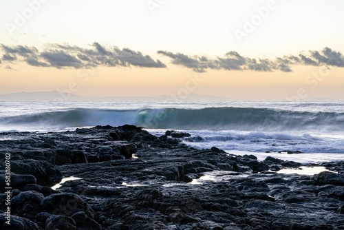 Beautiful seascape view with white and foamy waves against a scenic sunrise in Oahu  Hawaii