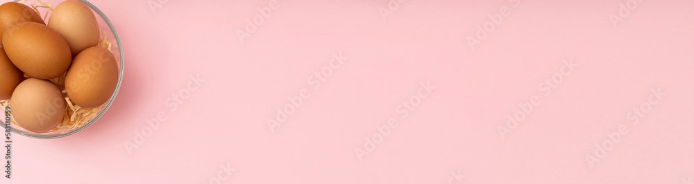 Banner with eggs in a bowl and a pink background