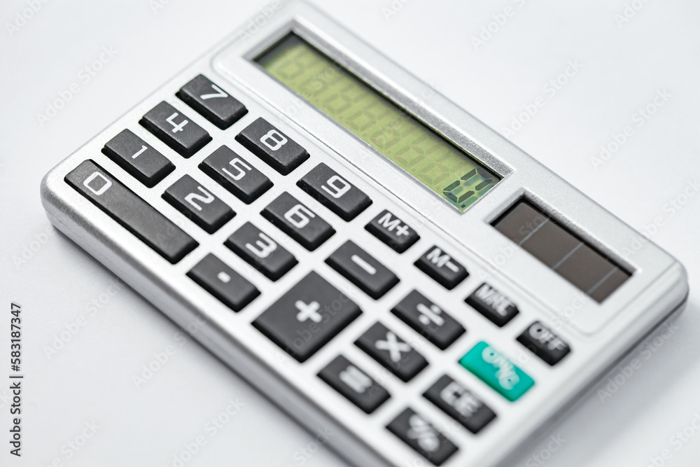 Calculator pocket with solar battery, zero on screen device for financial calculations, side view, selective focus Calculator pocket with solar battery, zero on screen device for financial calculations, side view, selective focus