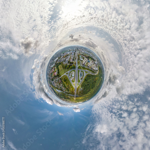 tiny planet in sky with clouds overlooking old town, urban development, historic buildings and crossroads. Transformation of spherical 360 panorama in abstract aerial view.