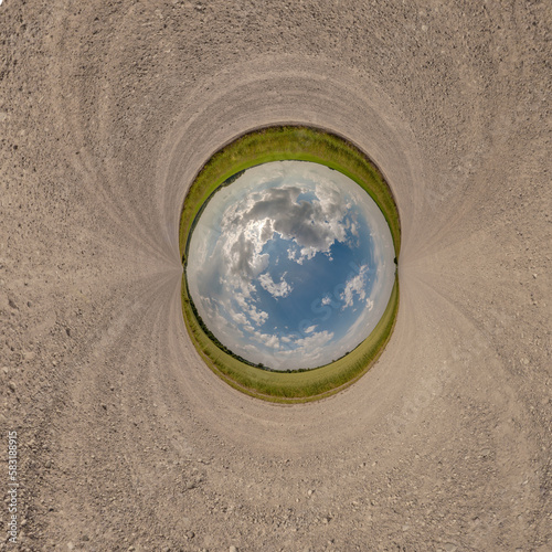 blue sphere little planet inside gravel road or field background. curvature of space