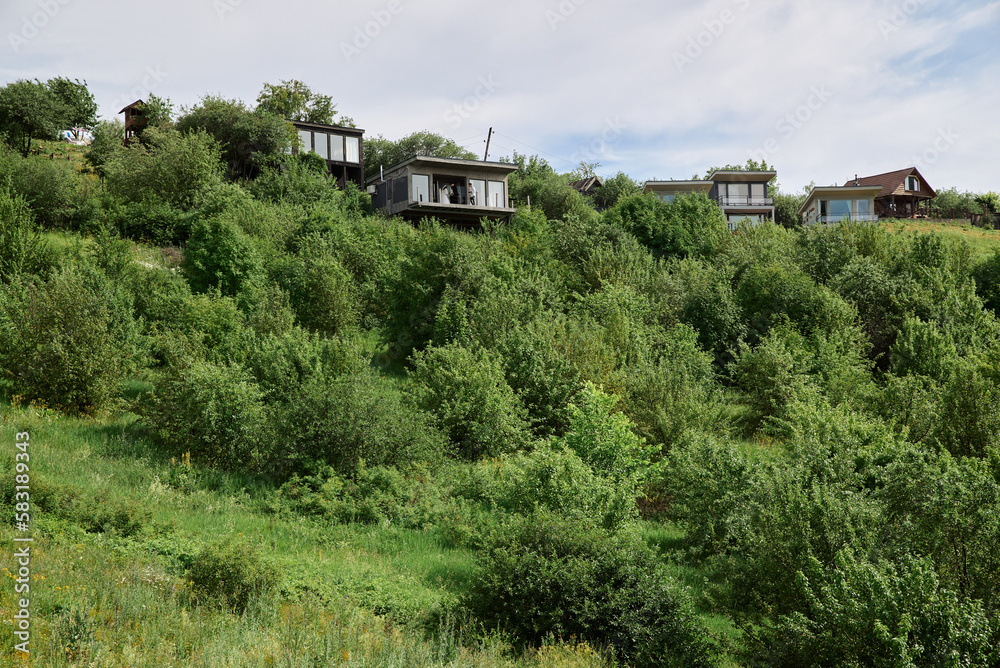country houses of frame type on the hills in nature