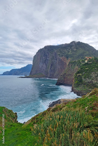 The green slopes of the island of Madeira in the ocean. Evergreen Island. Beautiful nature. A popular island for tourists.