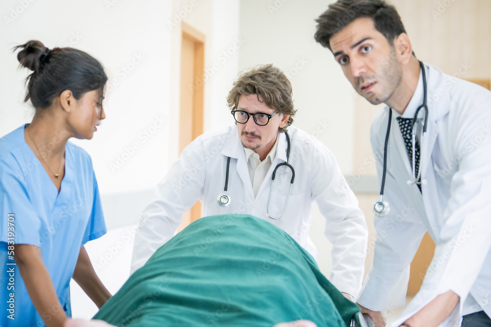 Doctor team and nurse staff carrying stretcher with patient from the accident ambulance running to the surgery room in hospital Doctor team and nurse staff carrying stretcher with patient from the accident ambulance running to the surgery room in hospital