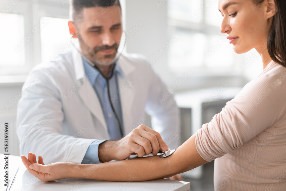 custom made wallpaper toronto digitalMale physician manually taking blood pressure using sphygmomanometer with stethoscope of young lady