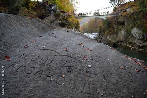 People on footbridge over Prut River and Probiy waterfall, western Ukraine photo