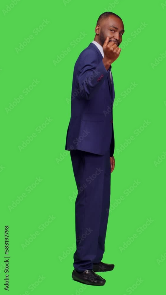 Vertical video: Profile of male employee in suit doing sign to come over, posing over isolated full body green screen backdrop. Startup worker calling people over, asking to join or accompany on Vertical video: Profile of male employee in suit doing sign to come over, posing over isolated full body green screen backdrop. Startup worker calling people over, asking to join or accompany on