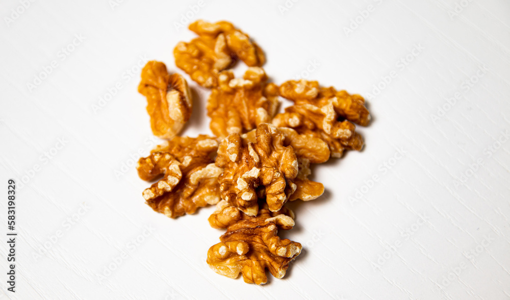 Walnuts on a white wooden background. Healthy food. Top view. Walnuts on a white wooden background. Healthy food. Top view.