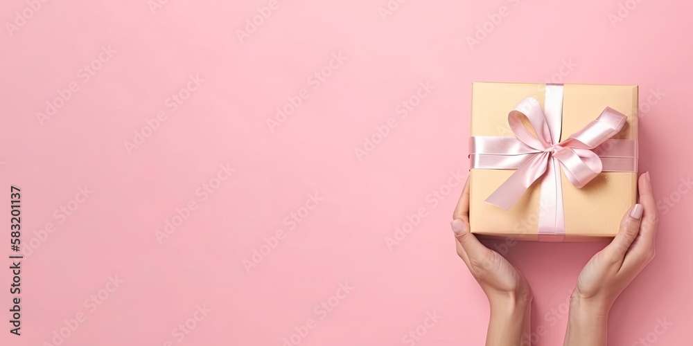 Gift in female hands on a colored background top view. Female hands hold gift box. Copy space for design