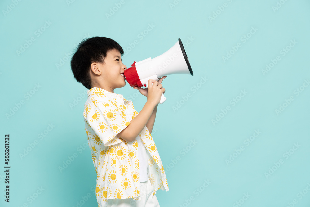 Side of Asian little boy holding megaphone isolated on green background, Speech and announce concept, Five years old Side of Asian little boy holding megaphone isolated on green background, Speech and announce concept, Five years old