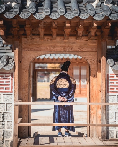 Canvas Print Vertical of a male dressed in the traditional hanbok Jeogori, walking around Gye
