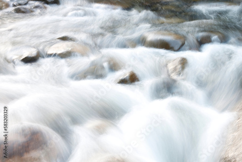 Beautiful image of the fluidity of the river water movement between the stones