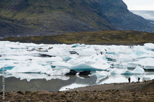 Jokursarlon glacier front with unrecognizable tourists photo