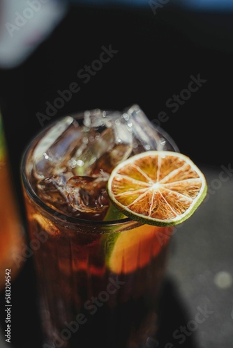 Fototapeta Naklejka Na Ścianę i Meble -  Closeup of an exotic and refreshing cold juice made of fruits served in a glass and with ice in it
