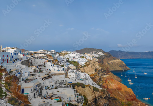 Panoramic view of Oia village on Santorini island, Greece. Town with cycladic white houses located on the cliffs of the island.
