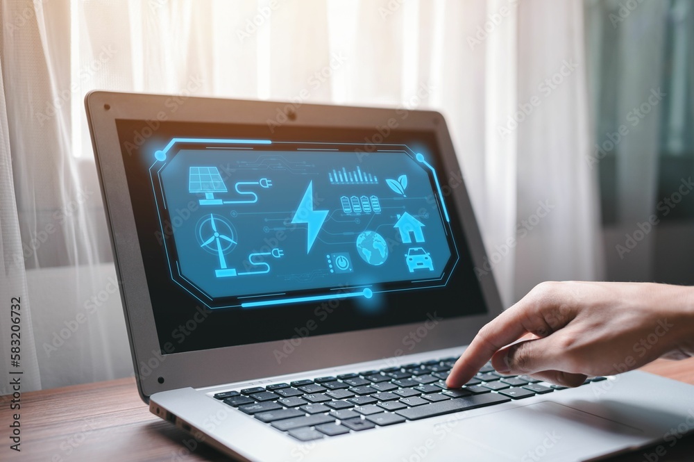 Man's hands typing on laptop with concept of solar power, wind power, hydropower on the screen Man's hands typing on laptop with concept of solar power, wind power, hydropower on the screen
