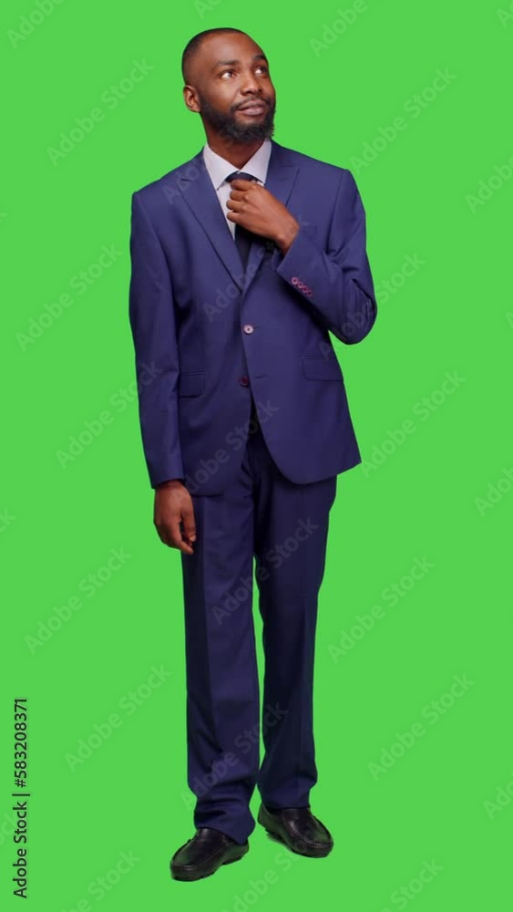 Vertical video: Front view of african american businessman saying wow being surprised, having shocked reaction in studio with greenscreen backdrop. Male employee in suit feeling amazed on camera Vertical video: Front view of african american businessman saying wow being surprised, having shocked reaction in studio with greenscreen backdrop. Male employee in suit feeling amazed on camera