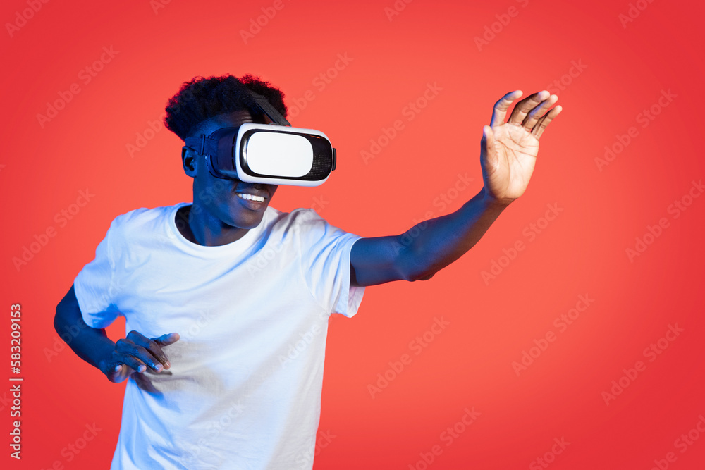 Happy african american guy using VR headset, virtual reality concept Happy african american guy using VR headset, virtual reality concept