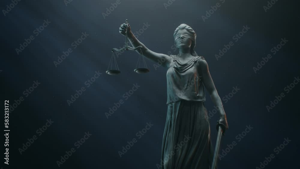 A Title Sequence for Court Show Mock-up. Cinematic and Atmospheric Shot of Lady Justice Sculpture in Dramatic Light. The Statue is Blindfolded and Holding Scales and Sword. A Title Sequence for Court Show Mock-up. Cinematic and Atmospheric Shot of Lady Justice Sculpture in Dramatic Light. The Statue is Blindfolded and Holding Scales and Sword.