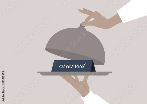 Waiter hands holding a tray and a cloche, a reserved sign