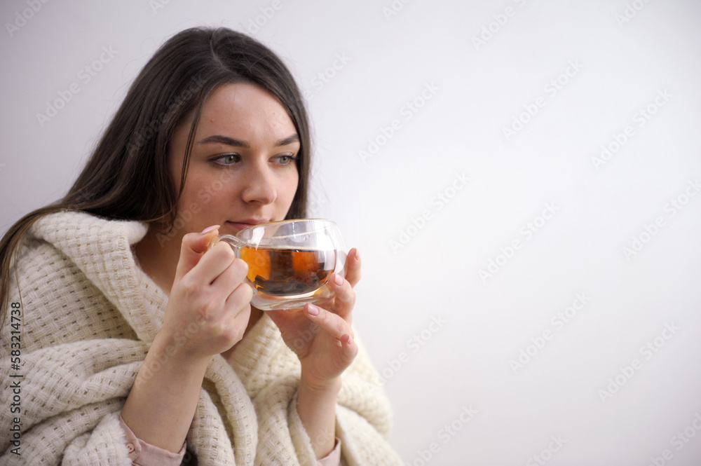 Portrait of joyful young woman enjoying cup of coffee at home. Smiling pretty girl drinking hot tea in winter. Excited woman wearing spectacles and sweater and laughing in an autumn day. High quality Portrait of joyful young woman enjoying cup of coffee at home. Smiling pretty girl drinking hot tea in winter. Excited woman wearing spectacles and sweater and laughing in an autumn day. High quality