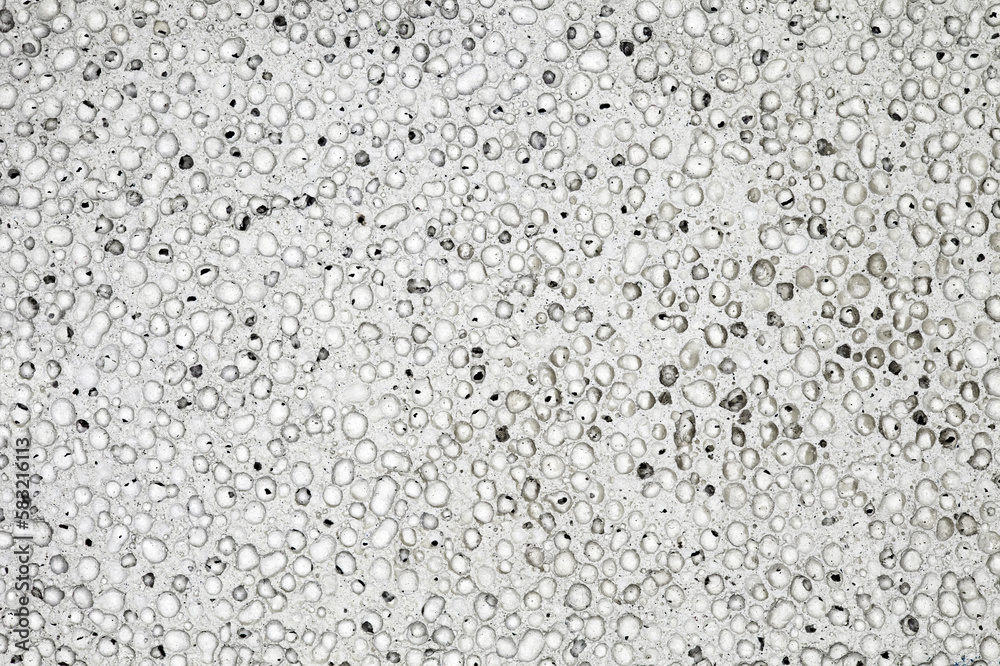 Pumice stone grey background close-up pumicite porous volcanic glass with frozen bubbles, background wallpaper, uniform texture pattern Pumice stone grey background close-up pumicite porous volcanic glass with frozen bubbles, background wallpaper, uniform texture pattern