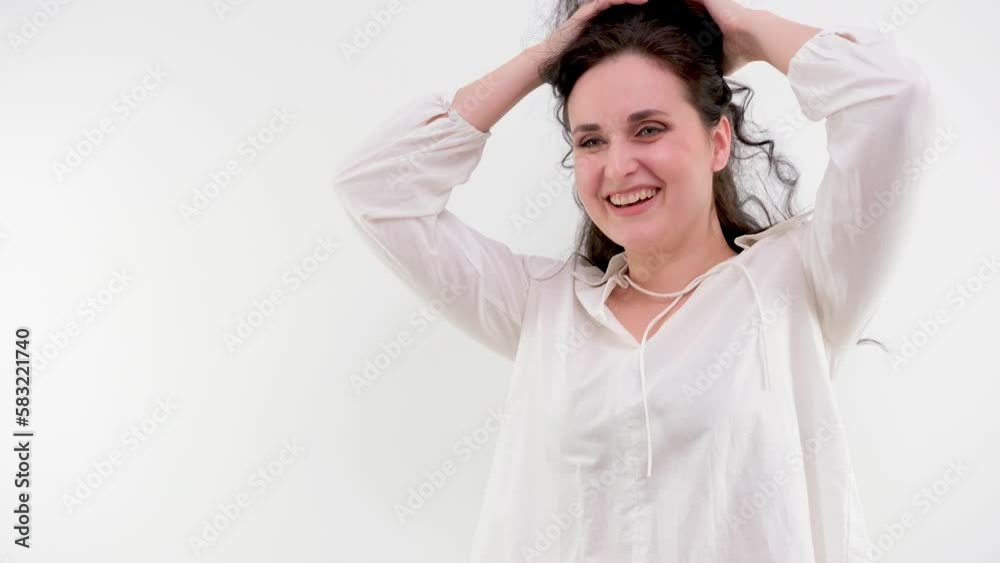 Close up head shot smiling young attractive woman looking in mirror, doing morning haircare routine in bathroom. Happy millennial teen lady arranging hair satisfied with strong healthy hair Close up head shot smiling young attractive woman looking in mirror, doing morning haircare routine in bathroom. Happy millennial teen lady arranging hair satisfied with strong healthy hair