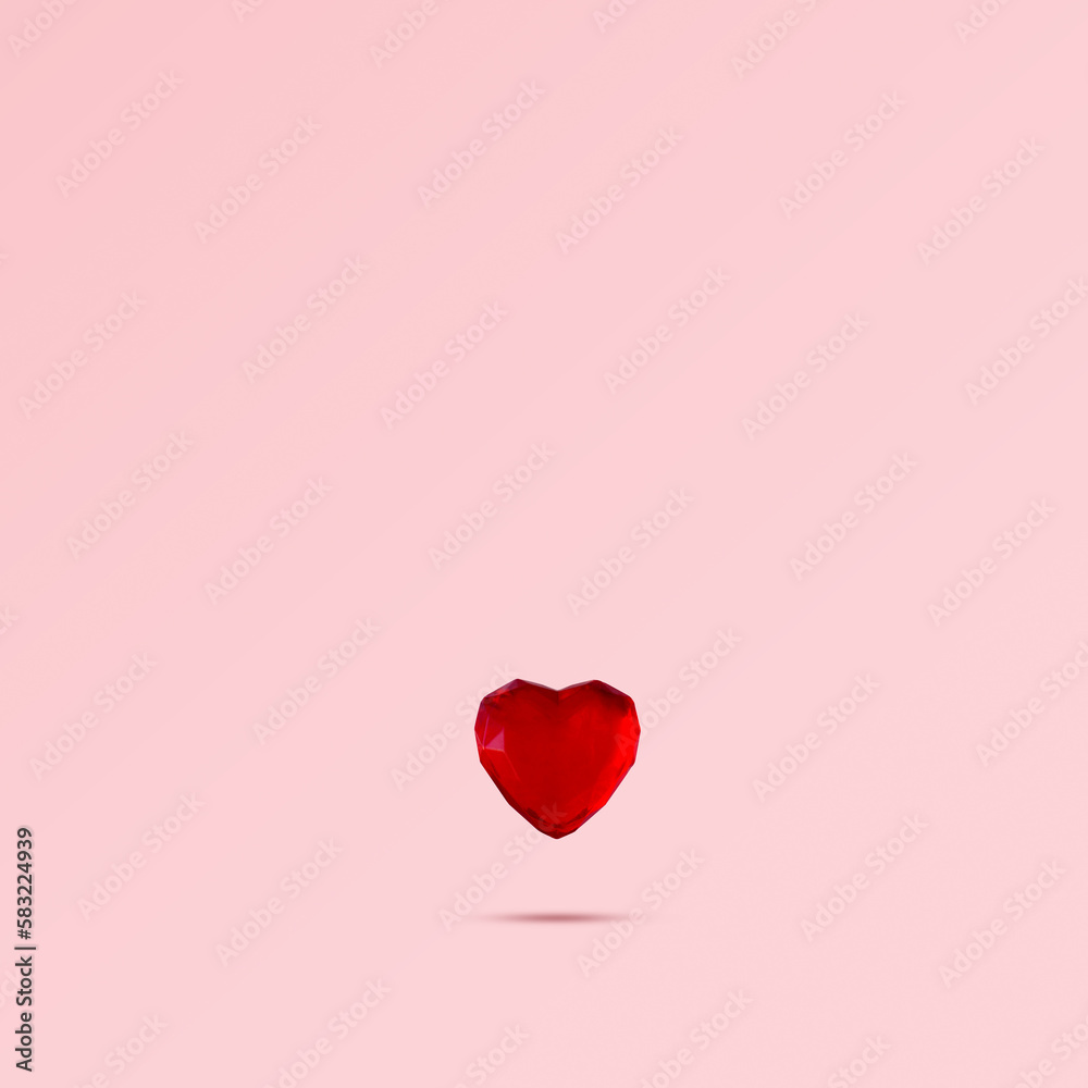 Red heart levitating against pink background. Minimal love concept, love background with copy space