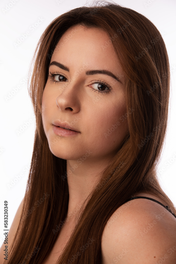 Studio portrait of a beautiful Ukrainian model in her 20s. She has brown hair and eyes. She is wearing a black tank top. Studio portrait of a beautiful Ukrainian model in her 20s. She has brown hair and eyes. She is wearing a black tank top.