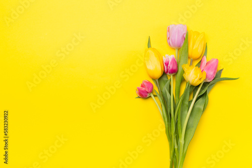 Fototapeta Naklejka Na Ścianę i Meble -  Bright tulips on color background, top view