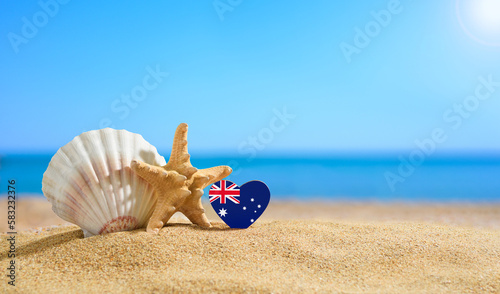Beautiful beach in the Australia. Flag of Australia in the shape of a heart and shells on a sandy beach.