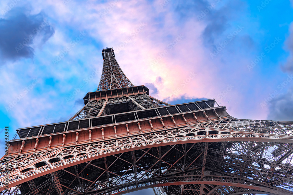 The Eiffel Tower in Paris against the backdrop of a beautiful evening sky.