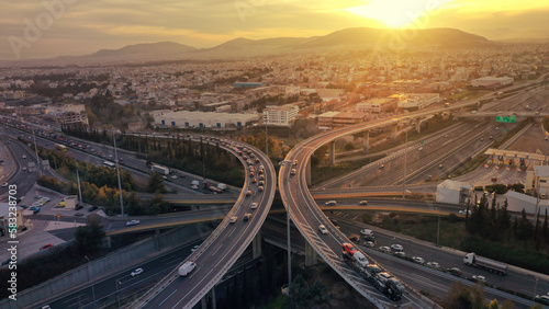 Aerial drone photo of modern Attiki Odos toll multilevel interchange highway with National road in Attica area at sunset  Athens  Greece