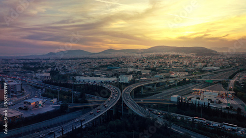 Aerial drone photo of modern Attiki Odos toll multilevel interchange highway with National road in Attica area at sunset, Athens, Greece © aerial-drone