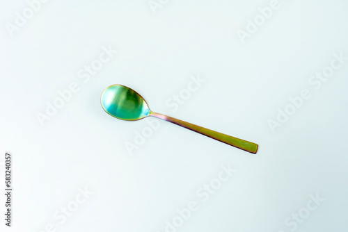 A salad spoon of iridescent material