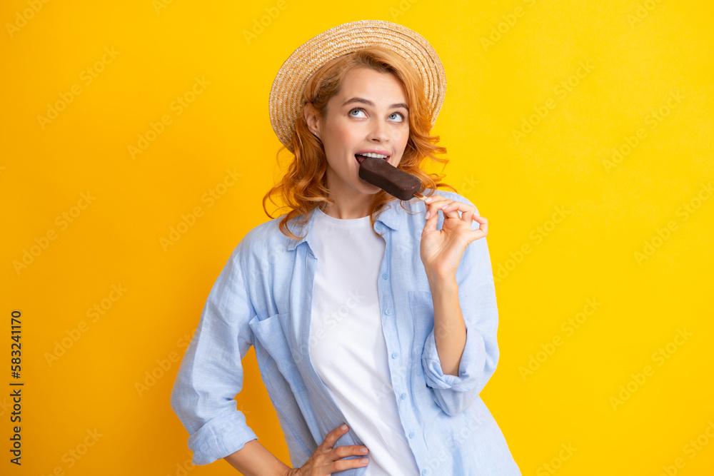 Portrait of redhead girl with chocolate ice cream on yellow background. Curly cheerful woman eating ice cream. Portrait of redhead girl with chocolate ice cream on yellow background. Curly cheerful woman eating ice cream.