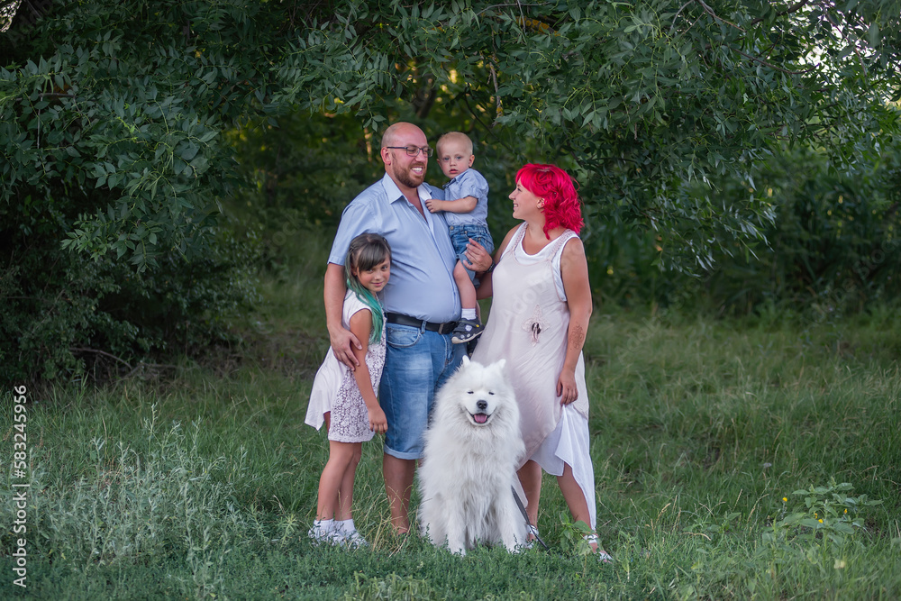 Portrait of bright, unusual, diversity family in nature with Samoyed dog. Traveling with pets. Portrait of bright, unusual, diversity family in nature with Samoyed dog. Traveling with pets.
