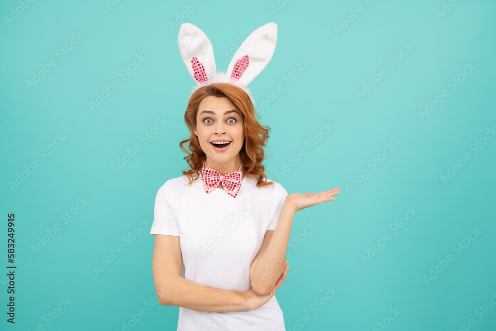 amazed easter woman with bunny ears on blue background amazed easter woman with bunny ears on blue background
