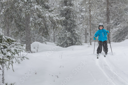 Young cross country skier in forest