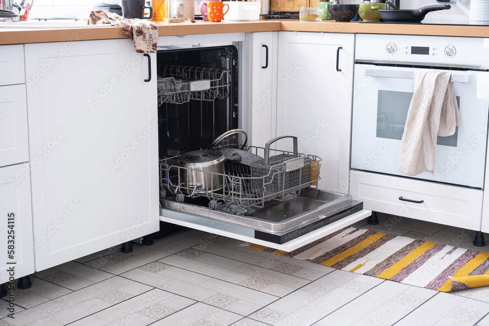 A mess in the kitchen, dirty dishes on the table, scattered things, unsanitary conditions. The dishwasher is full, the kitchen is untidy, everyday life A mess in the kitchen, dirty dishes on the table, scattered things, unsanitary conditions. The dishwasher is full, the kitchen is untidy, everyday life
