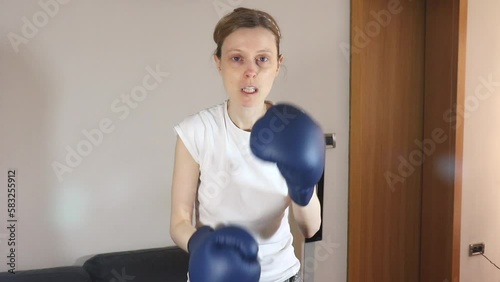 Young female boxer training at home