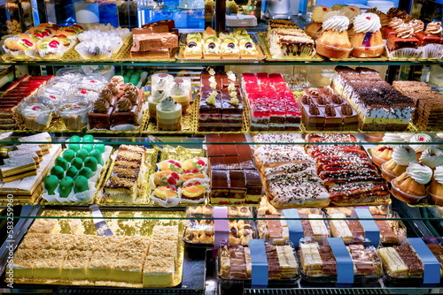 Showcase of different cakes in a confectionery shop © georgemuresan