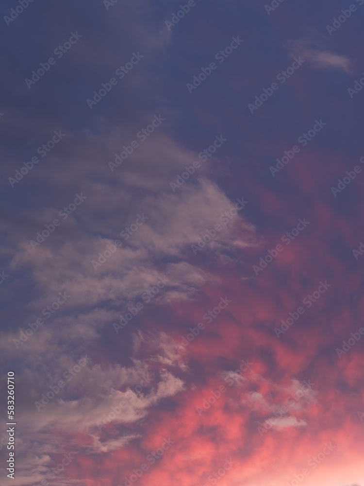 Dramatic colored clouds in sunset sky, portrait orientation