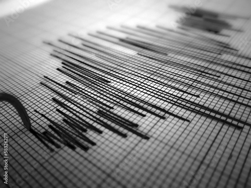    Richter scale Low and High Earthquake Waves vibrating on white paper background, sound wave diagram concept   